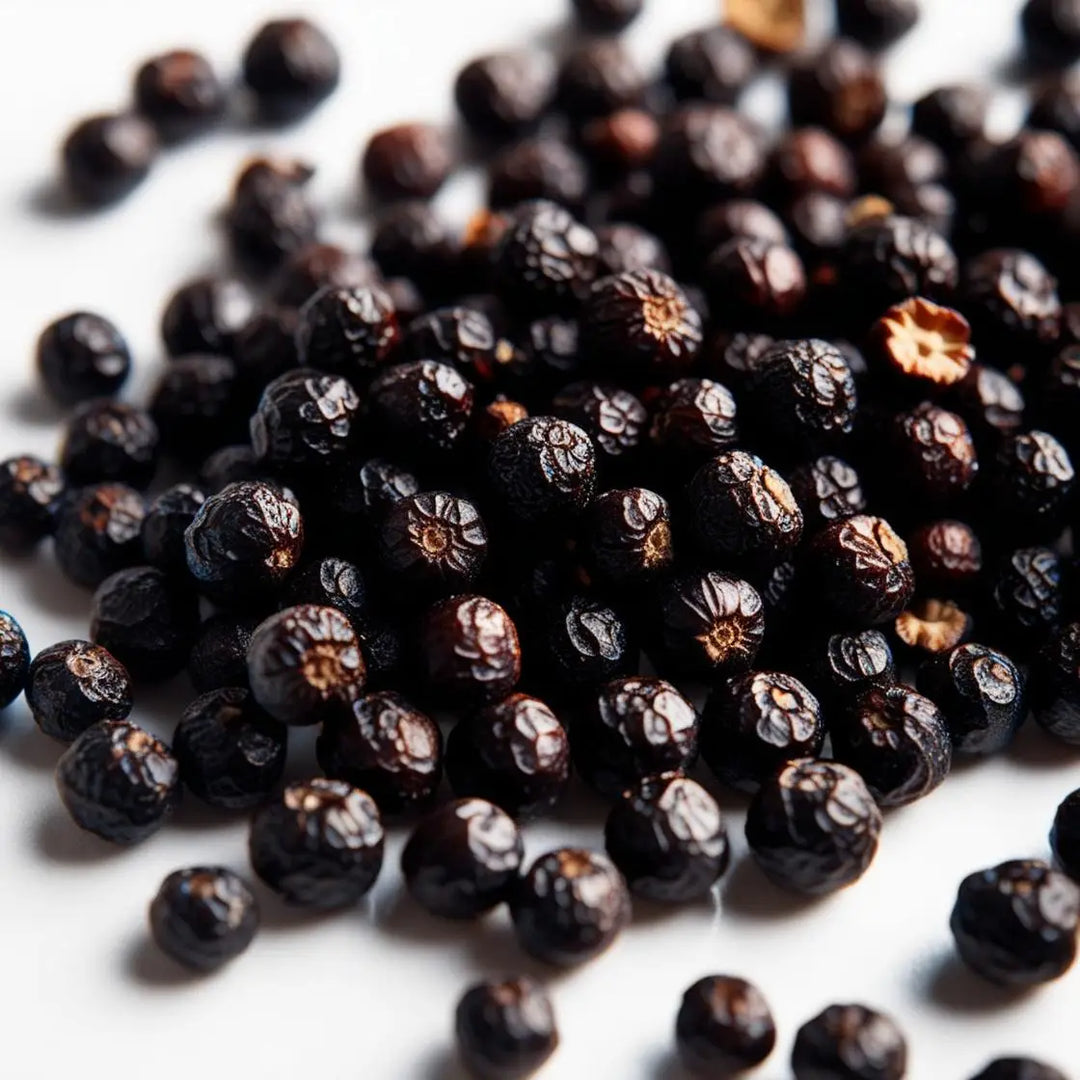 Black peppercorns in a wooden spoon, enhancing nutrient absorption from the Piper Nigrum plant.