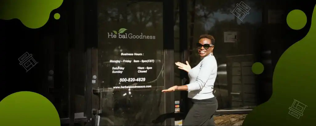 A person in business attire gesturing toward a storefront window.